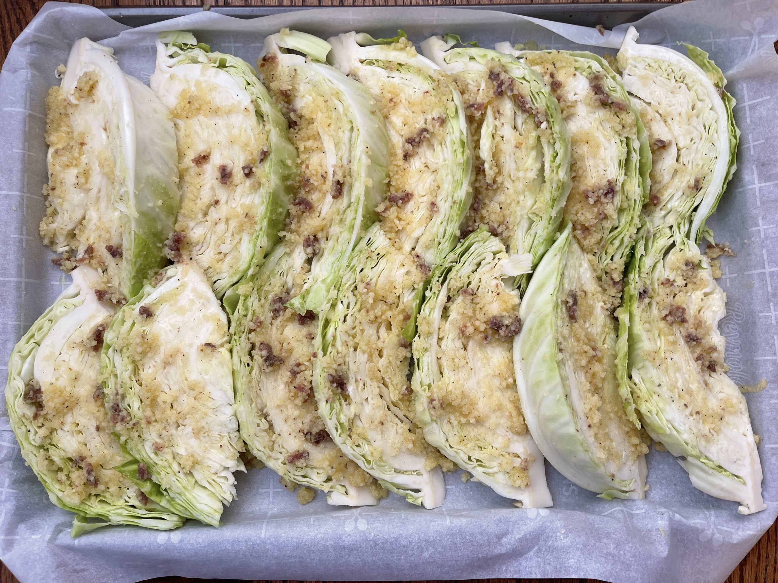massage paste into all of the crevices of the cabbage wedges and drizzle with more olive oil