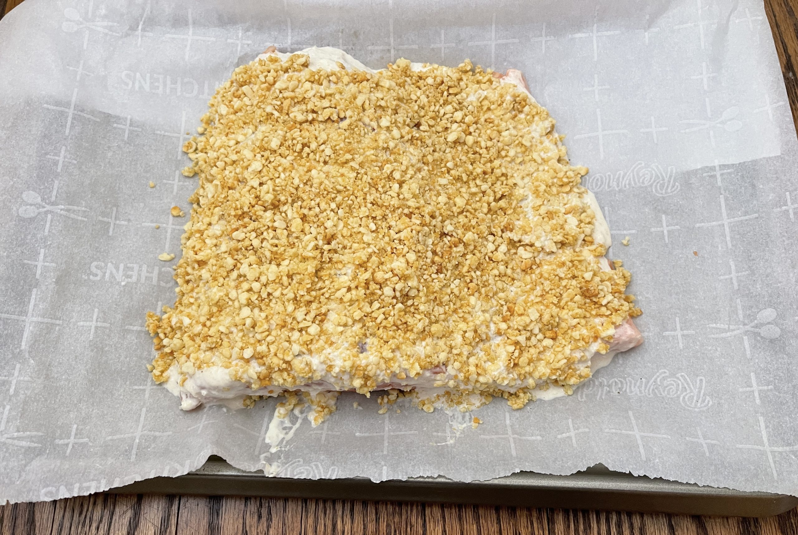 place gluten free panko on top of the horseradish mayo and gently pat down