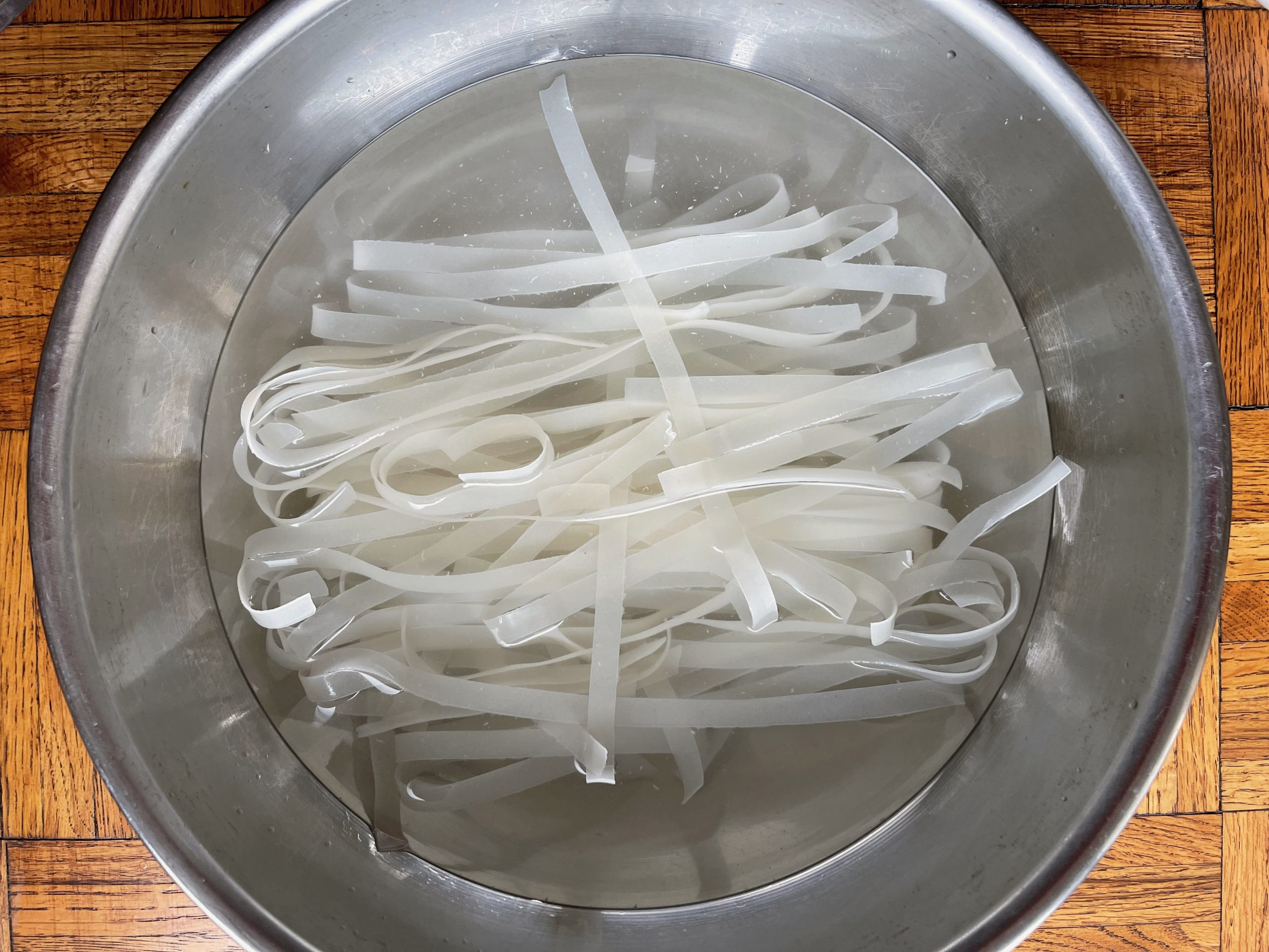 Soak rice noodles in a large bowl of hot tap water for 30-40 minutes