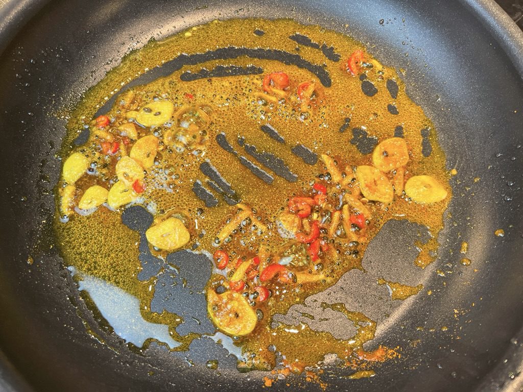 Next, add cardamom, coriander, and turmeric and cook, stirring, until fragrant, about 30 seconds.  
