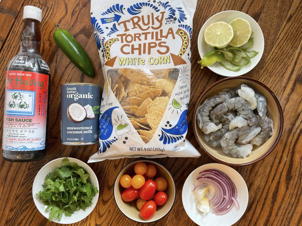 ingredients - shrimp, red onion, cherry tomatoes, lime, coconut milk, fish sauce, jalapéno, garlic, cilantro and gf corn tortilla chips