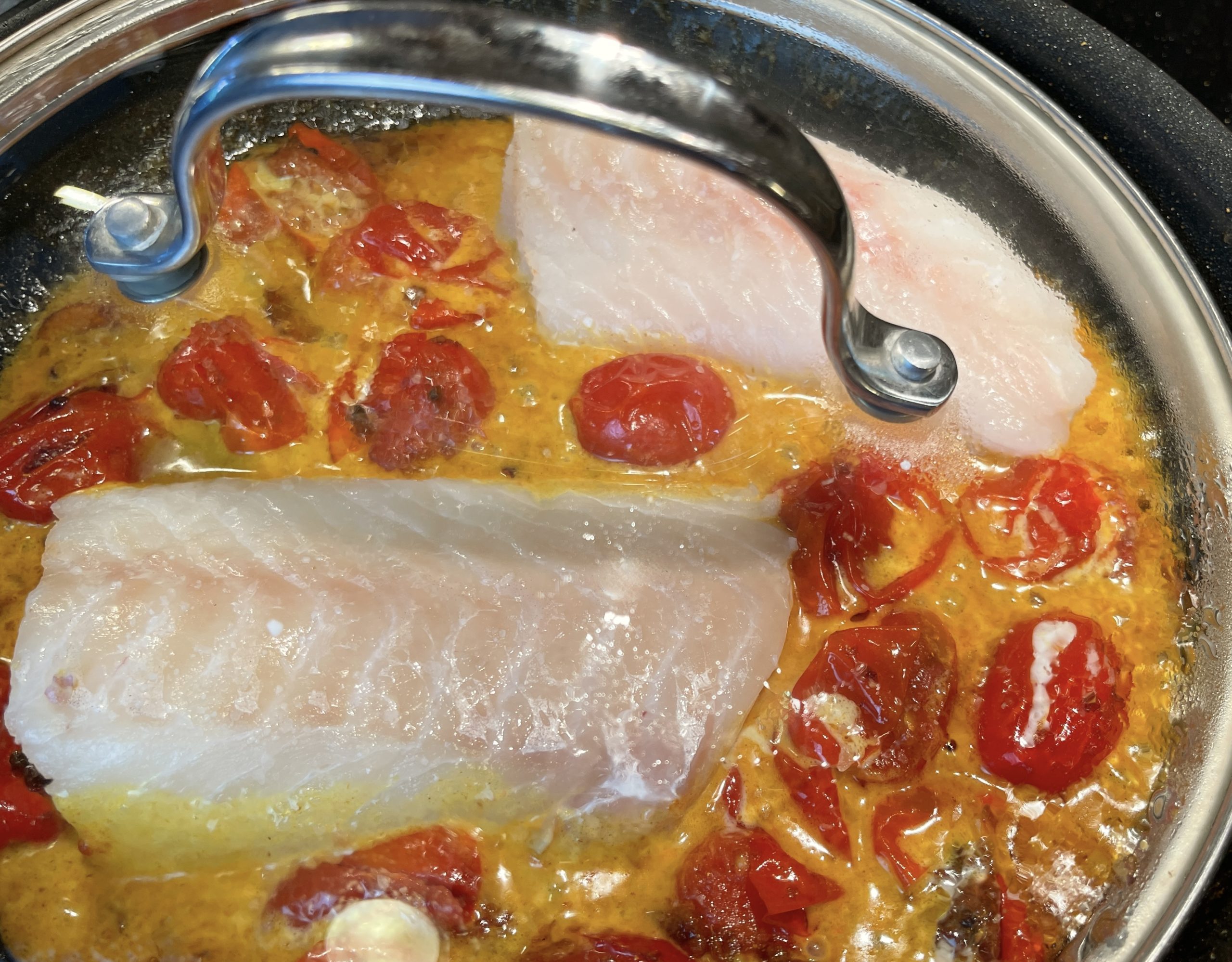 Reduce heat to medium-low.  Season fish with salt on both sides and then nestle into curry.  Cover and cook at a low simmer for 5-7 minutes.