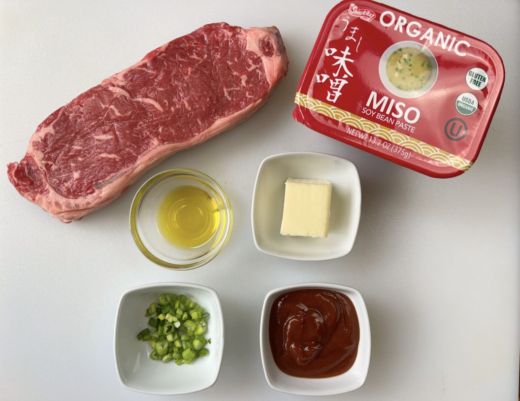 ingredients - strip steak, miso paste (white or yellow), butter, sriracha, olive oil, and scallions