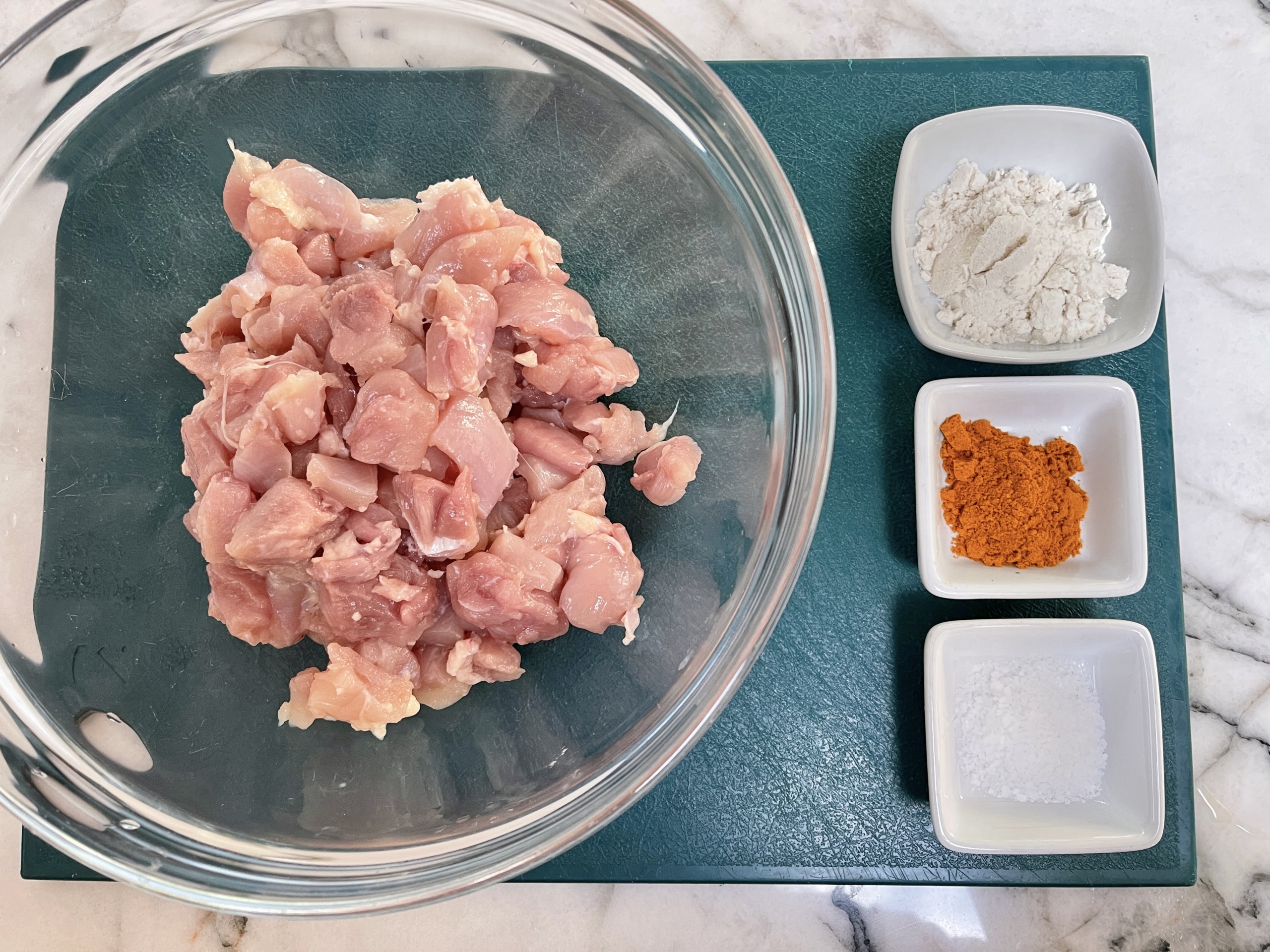 organize the chicken thigh chunks, turmeric, gf flour, and salt