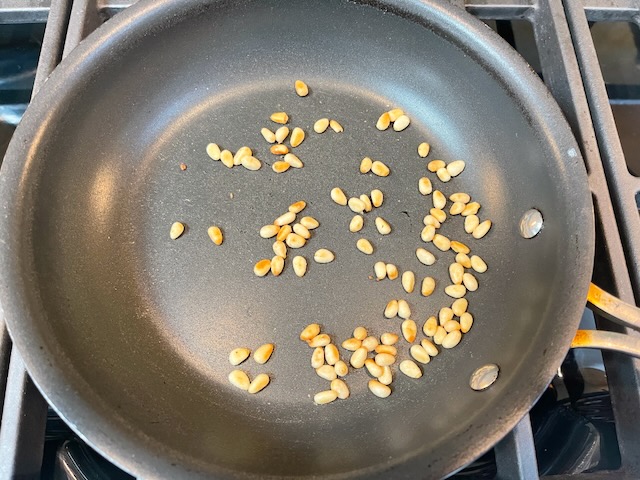 Cook pine nuts until lightly browned, approx. 3 mins