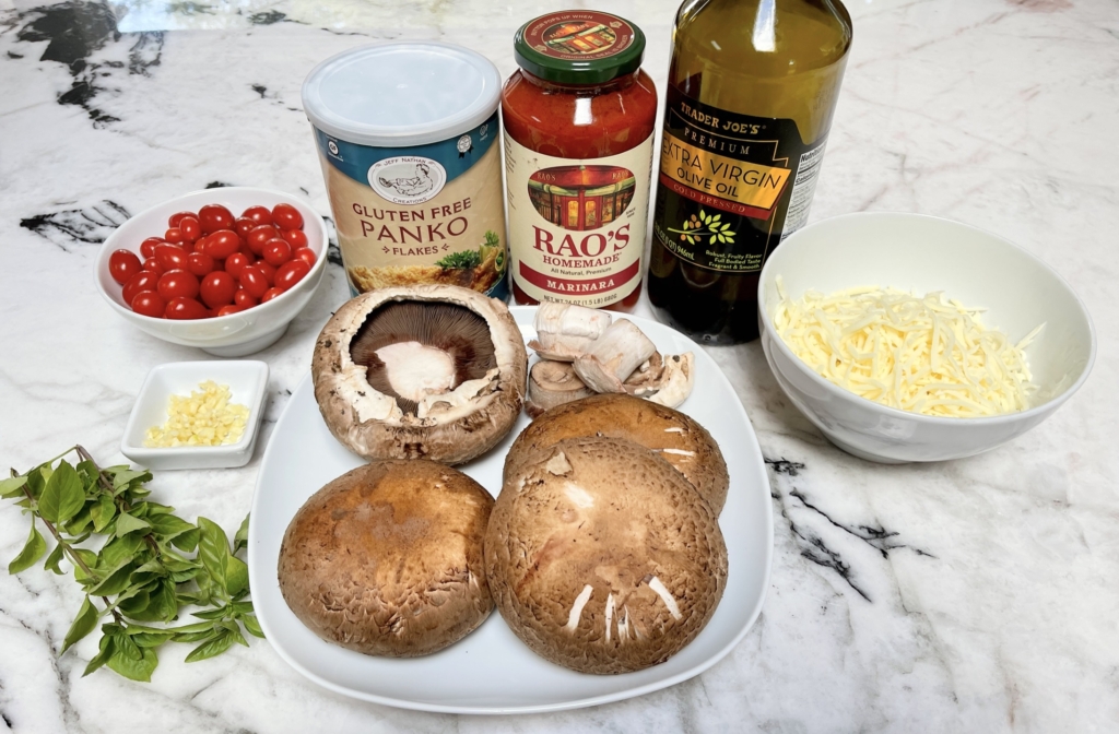 Organize the ingredients - mushroom caps, marinara sauce, shredded mozzarella, garlic, gf panko, cherry/grape tomatoes, olive oil and basil leaves