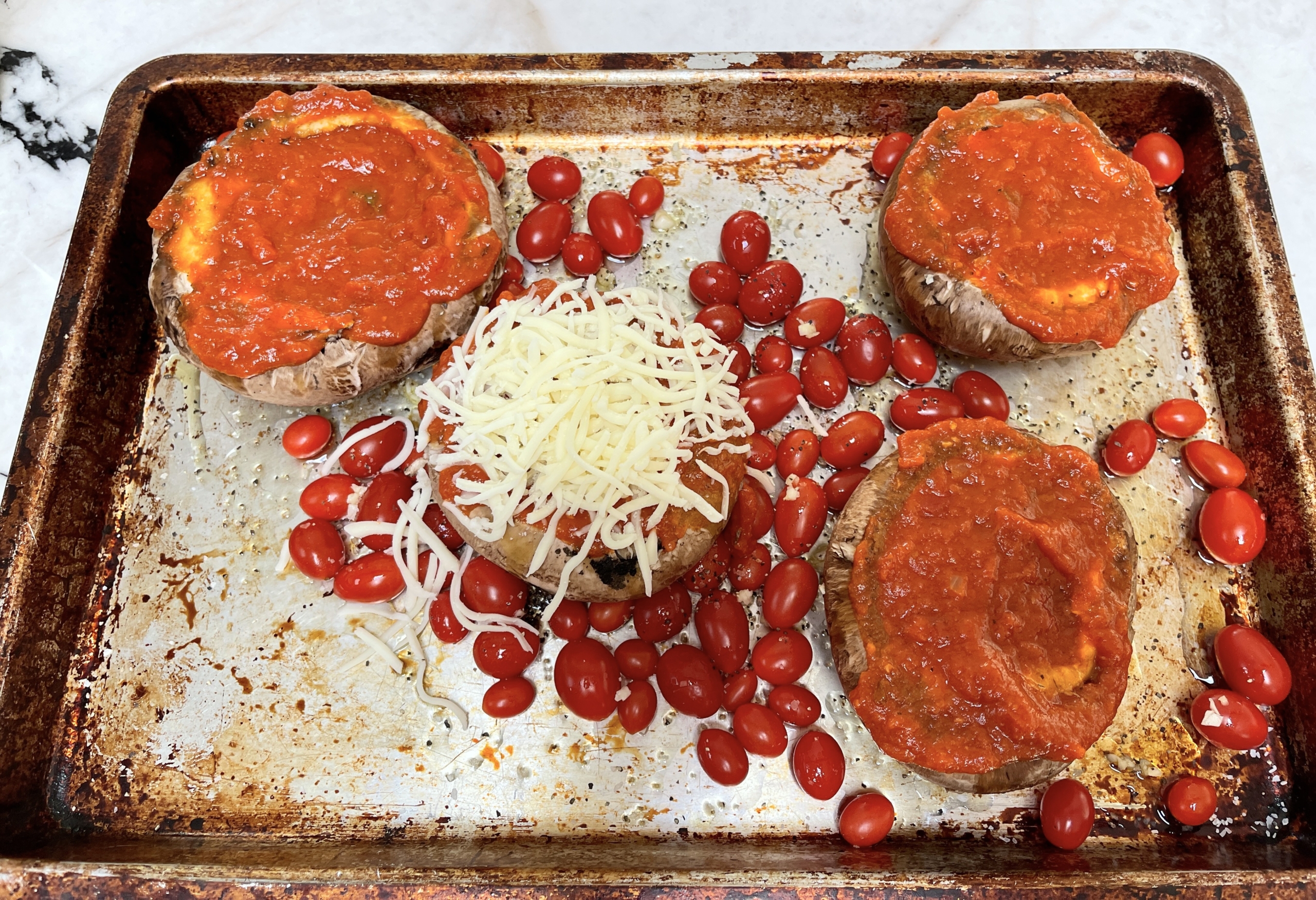 Scatter remaining garlic over the mushrooms and fill each cap with marinara sauce and cheese