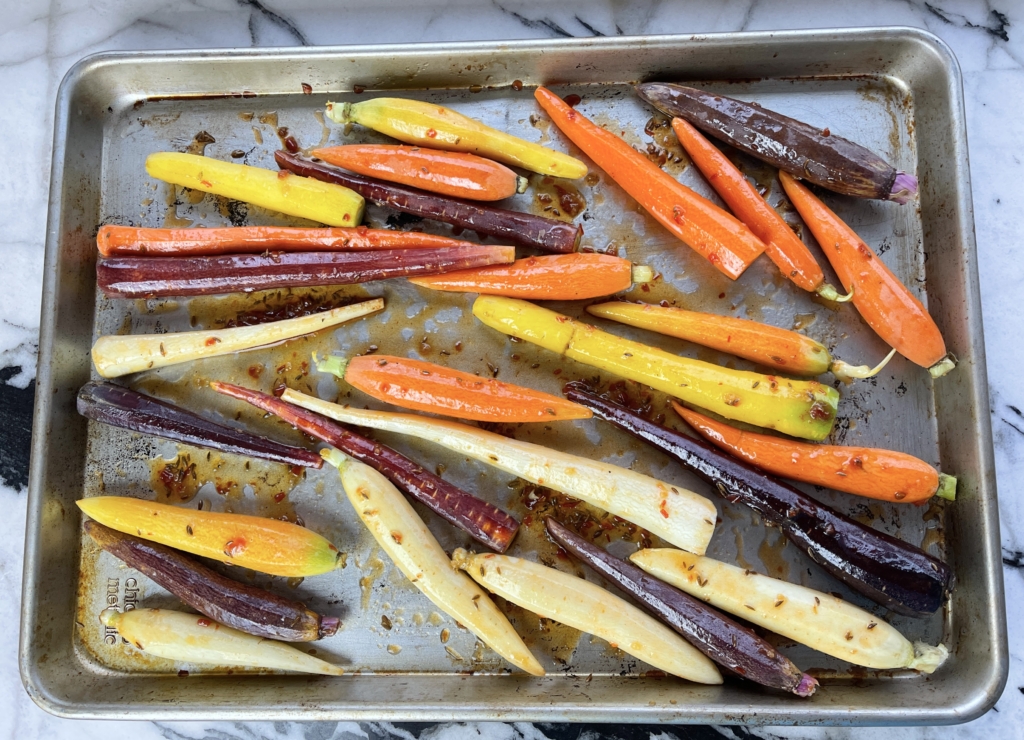 Place carrots on a disposable pan or double stacked baking sheets. Combine carrots with sauce using your hands or tongs.