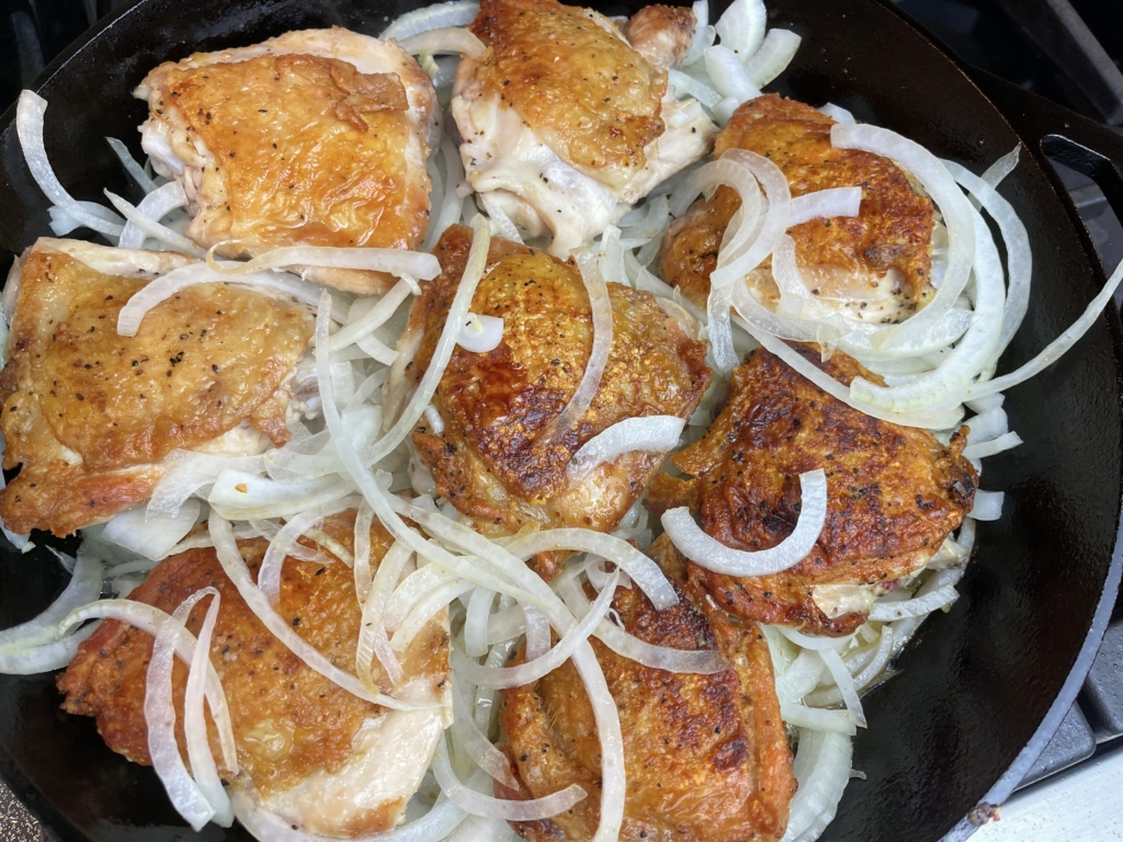 add onions and maneuver them underneath the chicken thighs.  cook chicken for an additional 15 mins.