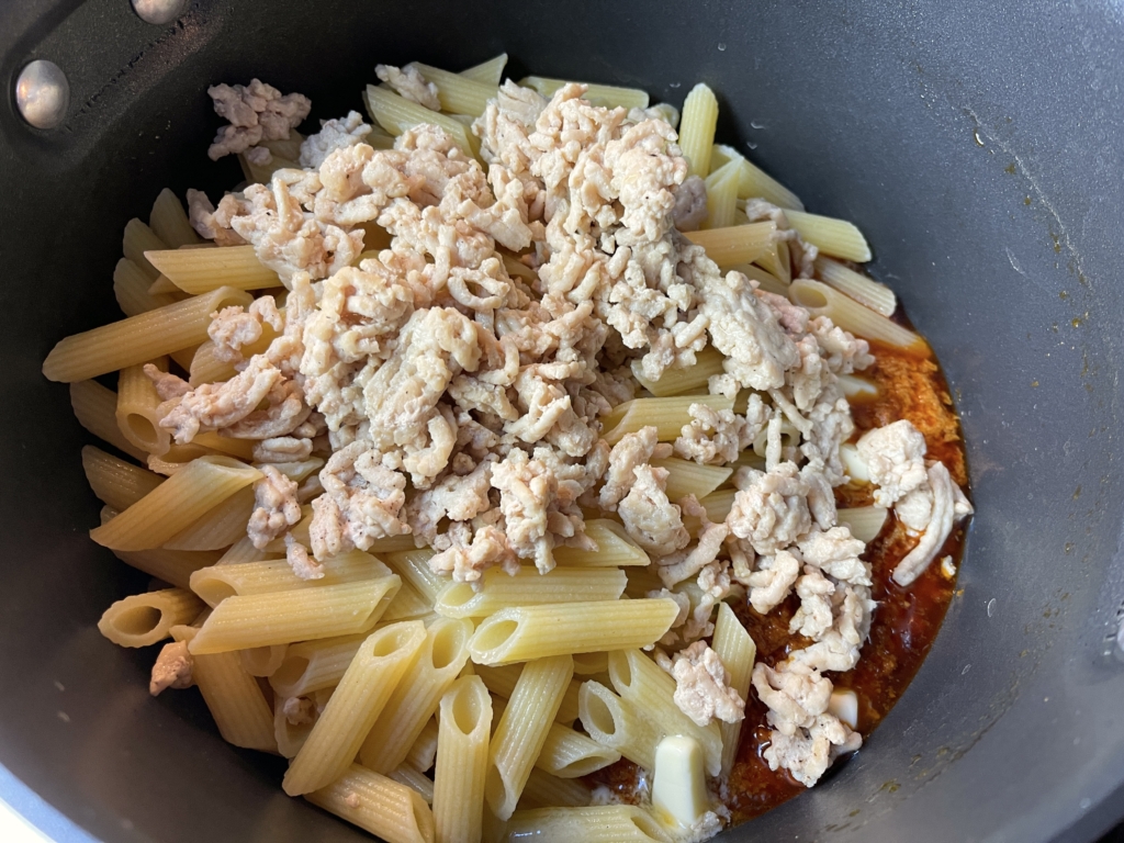 Transfer tomato walnut sauce to the pasta pot and add the chicken, pasta, butter, and starchy water