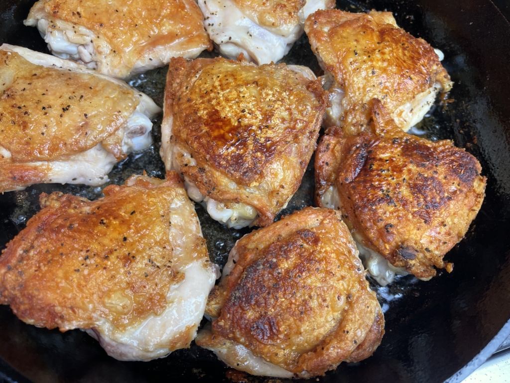 turn chicken pieces skin side up in pan