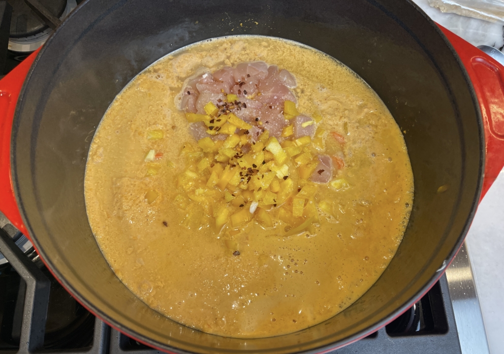 add the peanut butter puree into a large pot or dutch oven.  stir in the broth, chicken, bell pepper, carrots, hot pepper flakes, and salt. Simmer for 20-25 mins.