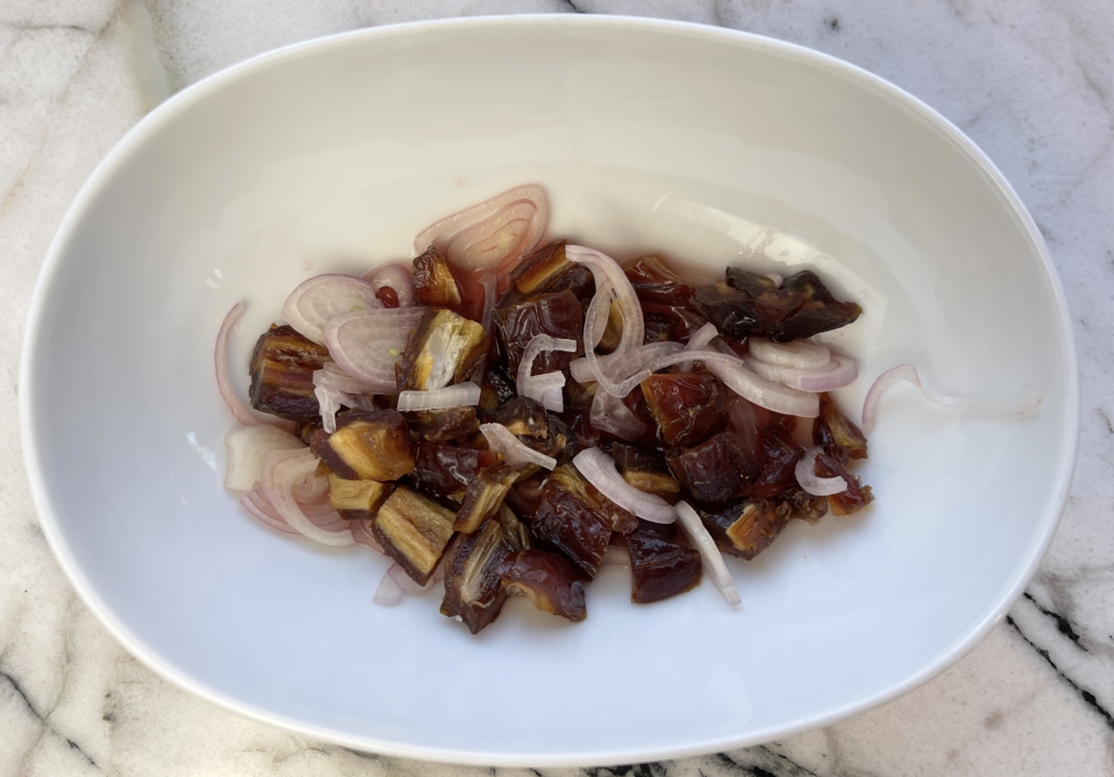 Place chopped figs (or dates), sliced shallots and remaining 2 tablespoons of vinegar in a bowl.  Let marinate for a minimum of 30 mins or as long as 4 hours.