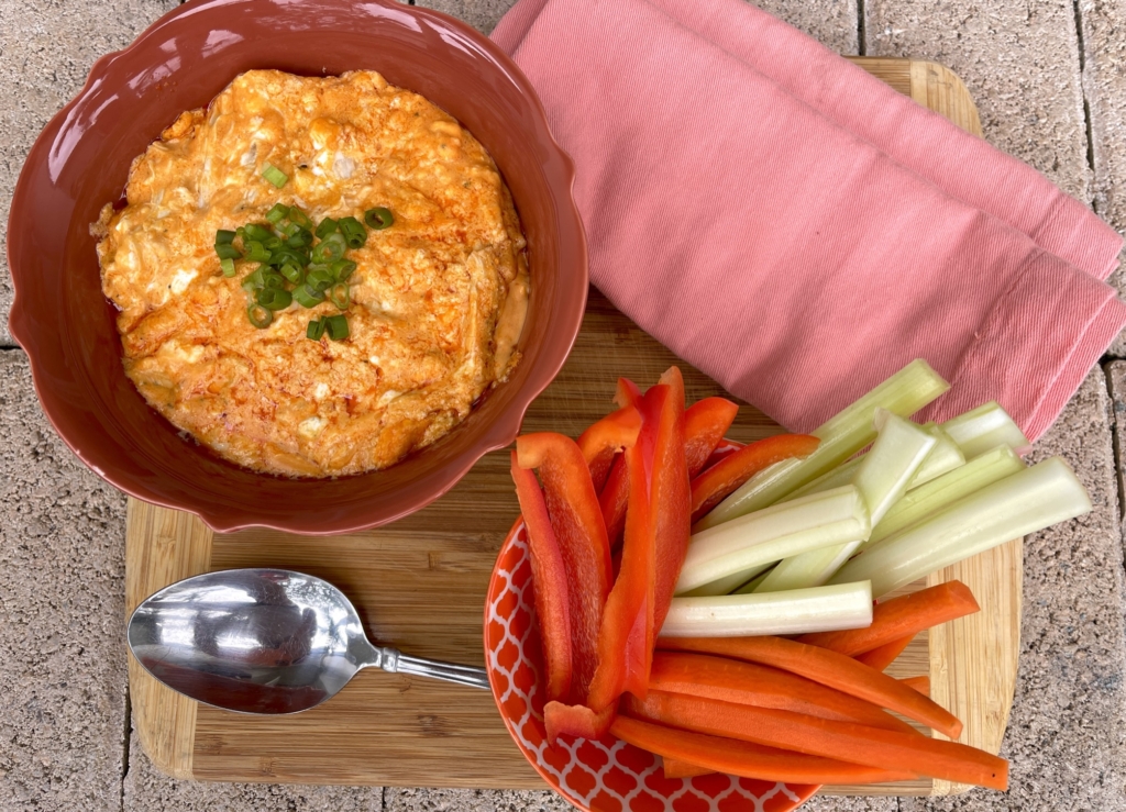 Simple Buffalo Chicken Wing Dip with sliced peppers, celery, and carrots