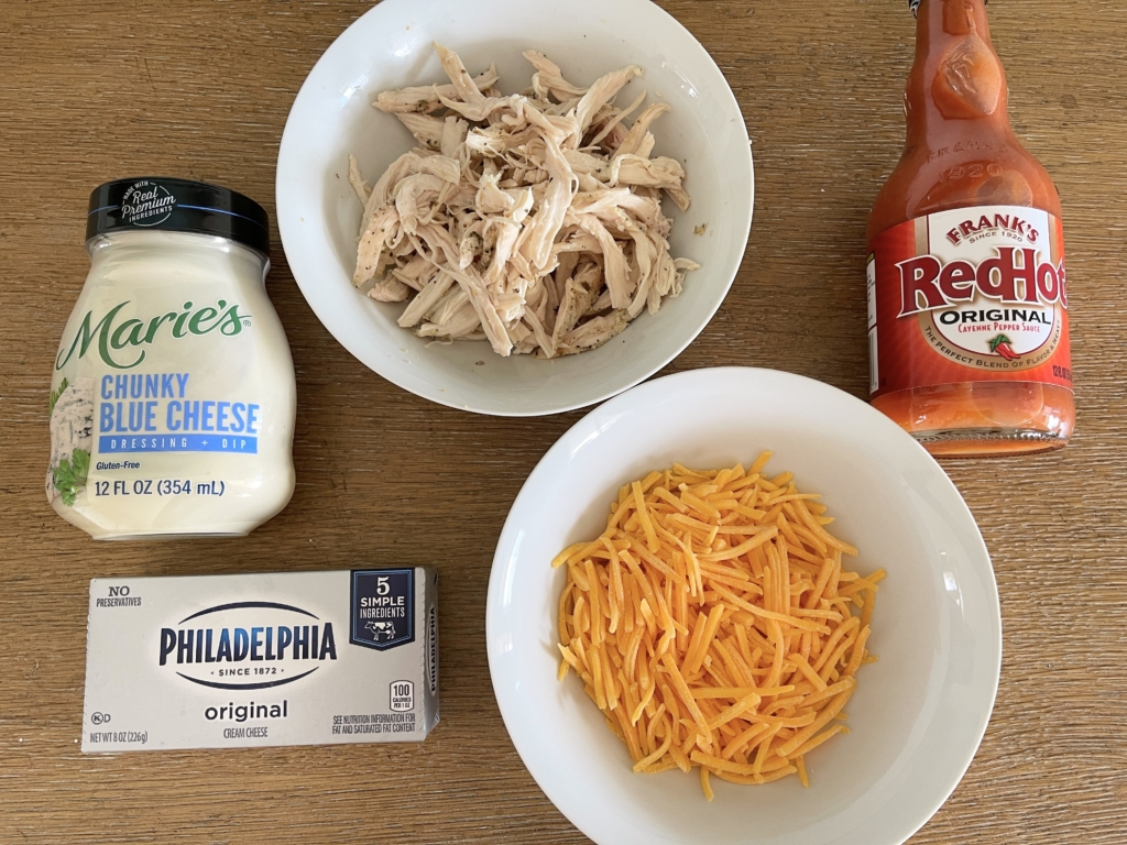 ingredients - shredded chicken, block of cream cheese, shredded mild cheddar cheese, Franks Red Hot Sauce and Marie's Blue Cheese Dressing