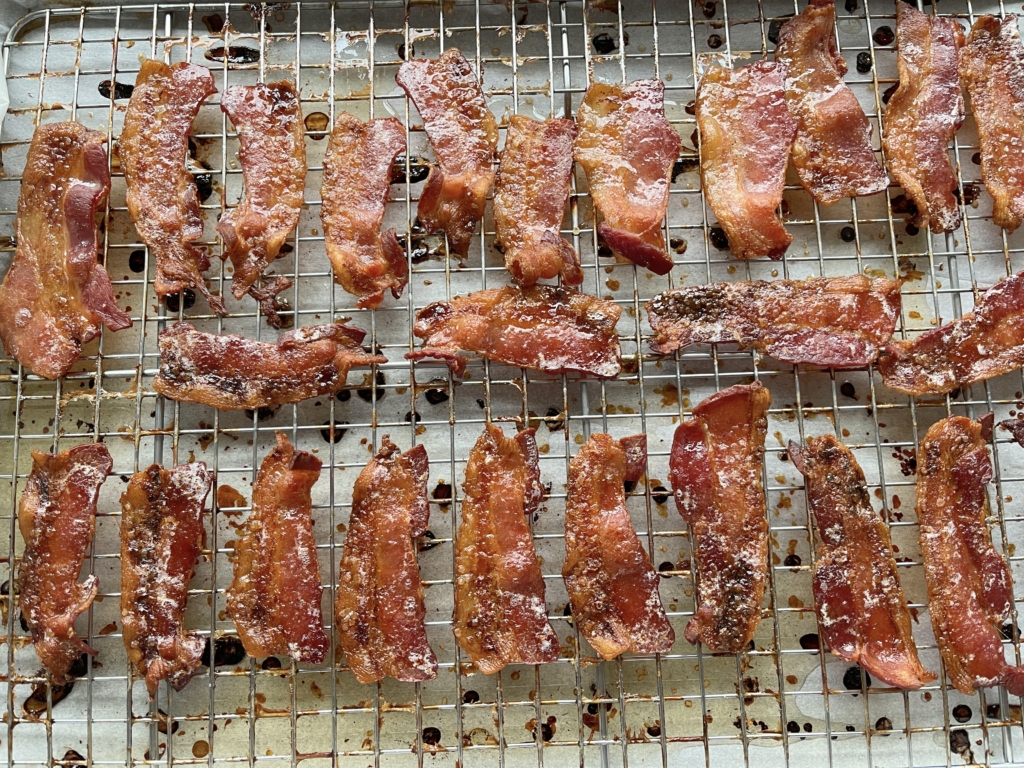 Cook bacon in a 400 degree oven for 10 mins.  Then sprinkle sugar over each bacon slice and continue cooking for 15-20 additional mins.  Total cook time 25-30 mins