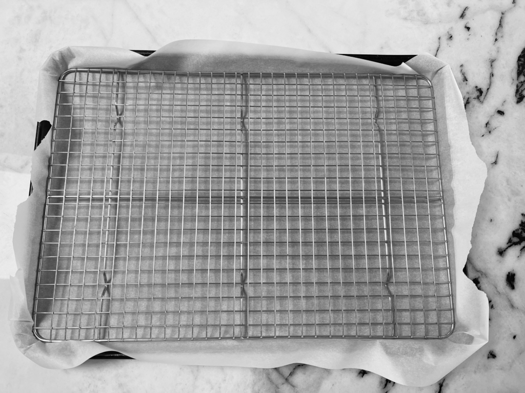 Place baking rack inside of parchment-lined baking sheet