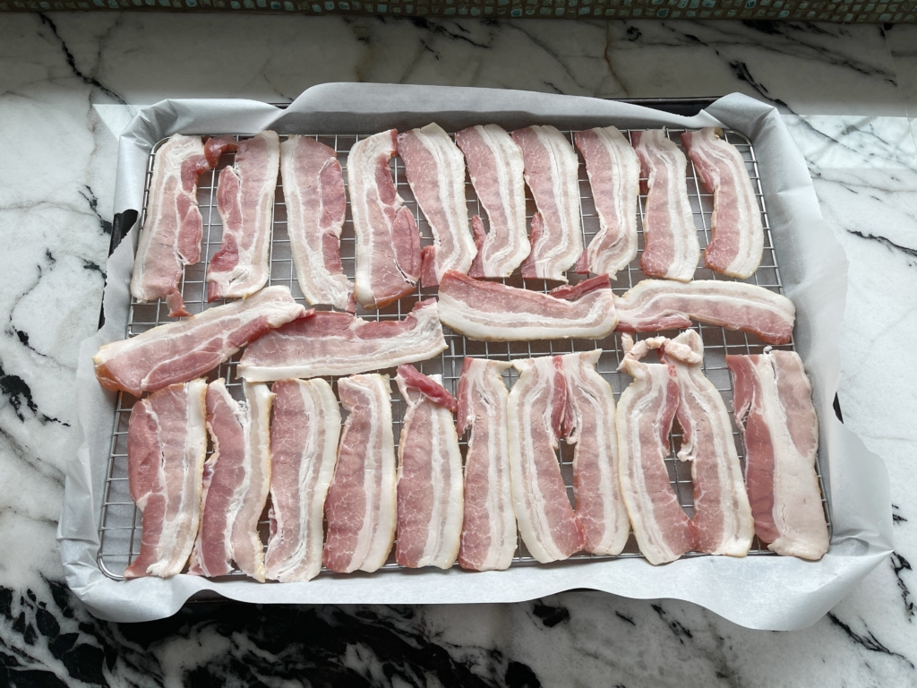 Add bacon slices on top of the rack without overlapping the slices
