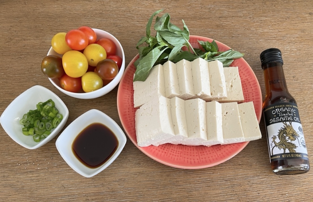 ingredients - silken tofu, gluten free soy sauce, cherry tomatoes, sesame oil, scallions, and fresh basil