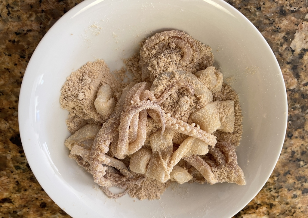 Coat calamari thoroughly with the graham cracker/flour mixture.