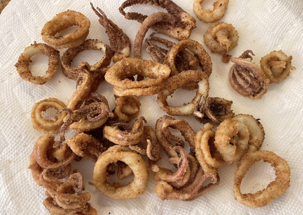 Using a slotted spoon, remove calamari and place on a paper towel lined plate.  Wait for oil to heat back to 360 degrees and then add the next batch