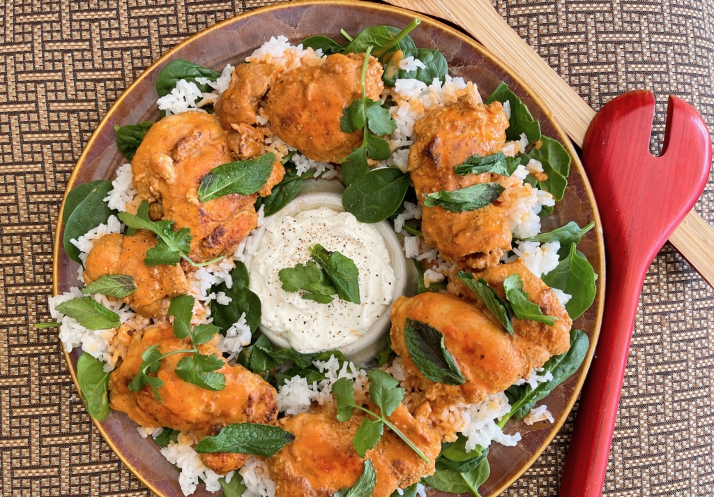 Place rice on a platter. Then transfer chicken to the platter and top with fresh cilantro and mint. 
Serve with a side of plain yogurt.Weeknight Indian-Spiced Chicken