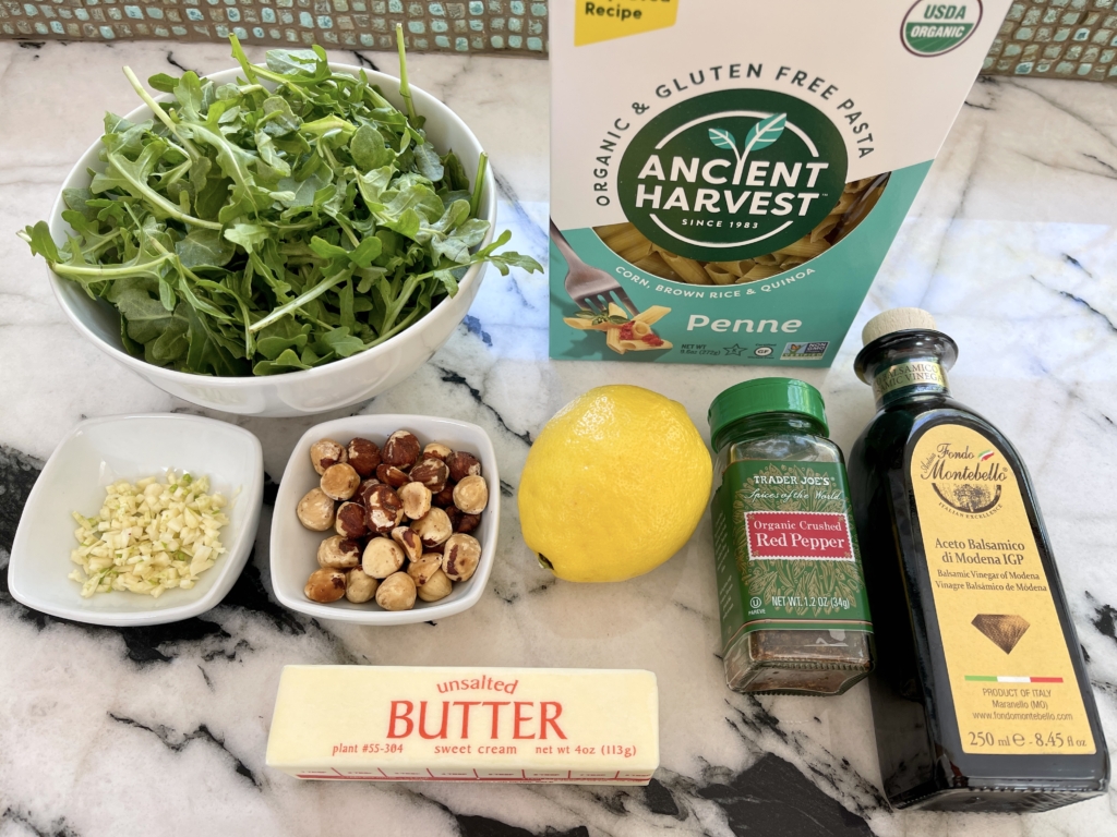 organize the ingredients - gf pasta, arugula, hazelnuts, garlic, lemon, butter, olive oil, and red pepper flakes