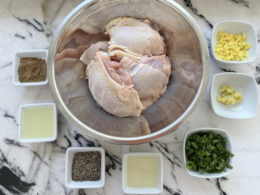 Chicken and Rub ingredients - 8 thighs or 4 chicken breasts, minced garlic and ginger, finely chopped cilantro, fresh lime juice, black pepper, neutral oil, and ground coriander.