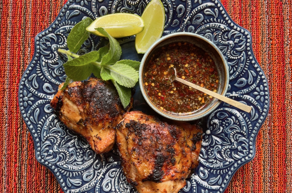 To serve, place chicken pieces and dipping sauce onto a platter and garnish with lime and fresh herbs.