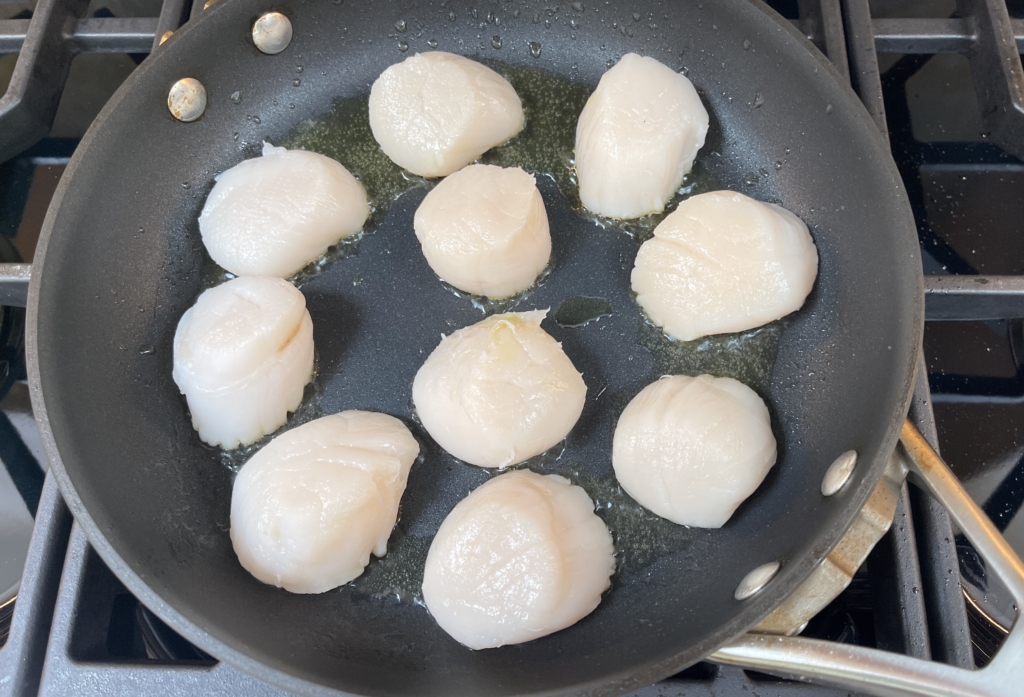 place scallops in a heated pan with olive oil