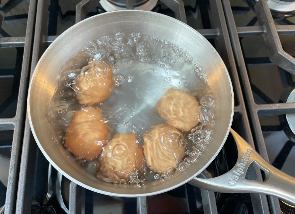 Once boiling, gently lower ALL eggs into the water using a large spoon. Keep the water at a medioum boil the whole time.
