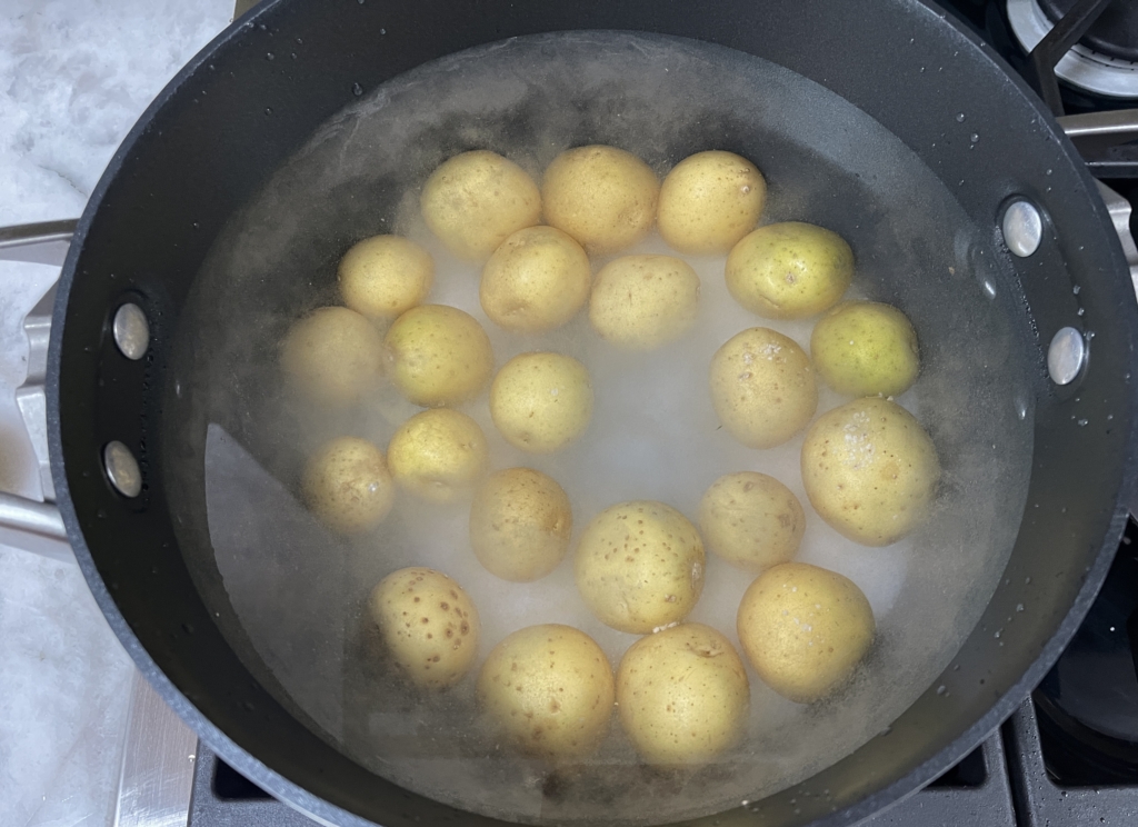 Boil potatoes in heavily salted water for 15-20 minutes, until potatoes are fork-tender. Remove 1/2 cup of the cooking liquid.