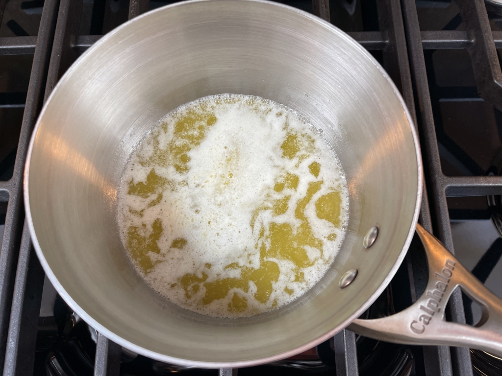 Melt one stick of butter over low heat in a saucepan.