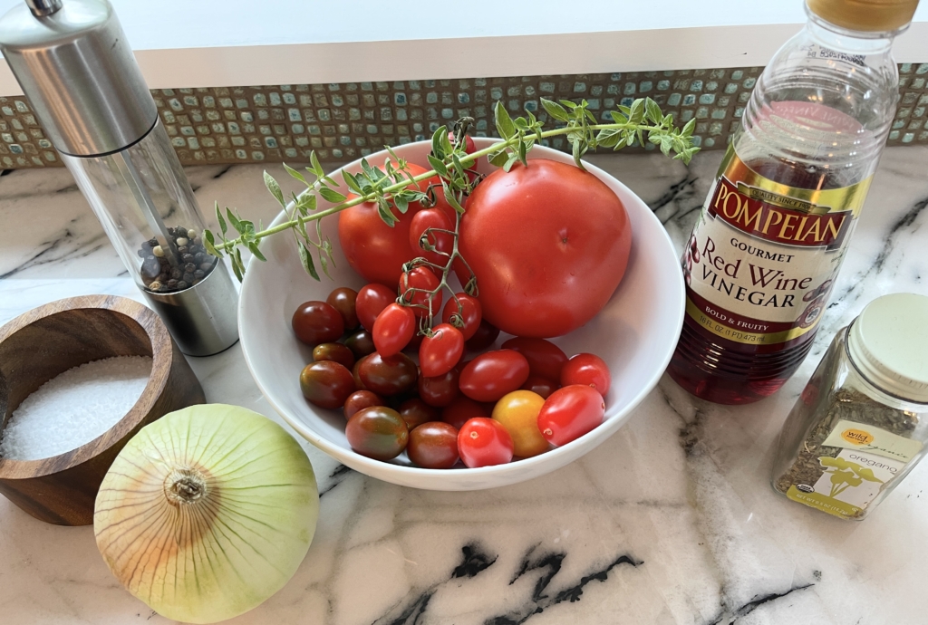 ingredients - tomatoes (any color or size), vidalia onion, fresh and dried oregano, red wine vinegar and extra virgin olive oil, and kosher salt and freshly ground pepper.