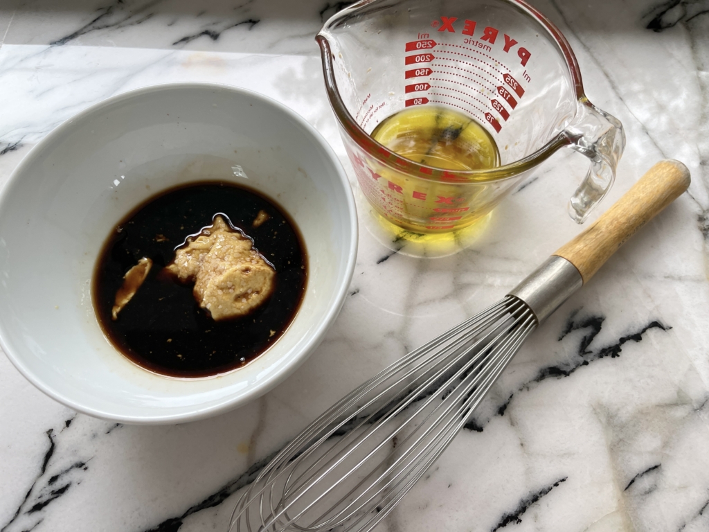 Place Dijon Mustard, balsamic vinegar, maple syrup and a pinch of kosher salt in a medium sized bowl.