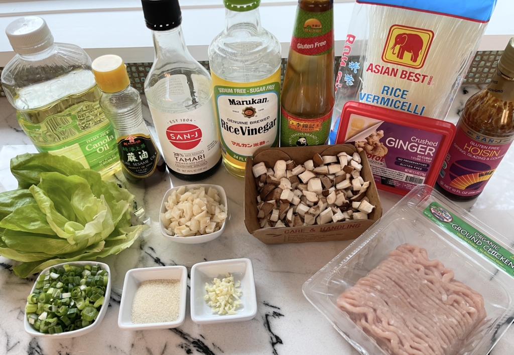 organize the ingredients - lettuce leaves, ground dark meat chicken, shiitake mushrooms, rice vermicelli noodles, water chestnuts, scallions, gf soy sauce, gf hoisin, gf oyster sauce, neutral oil, sesame oil , garlic, ginger, and sugar.