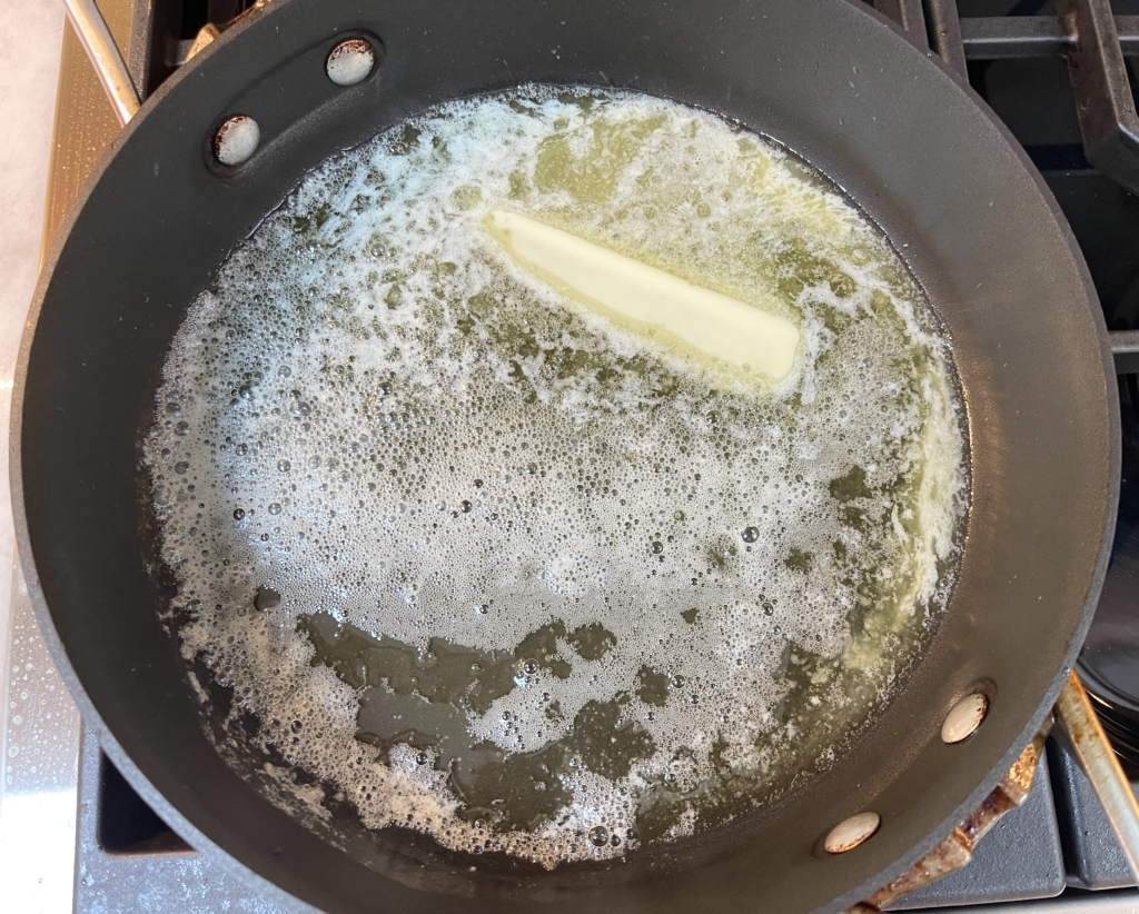 Melt butter in a large non-stick pan over moderately low heat.