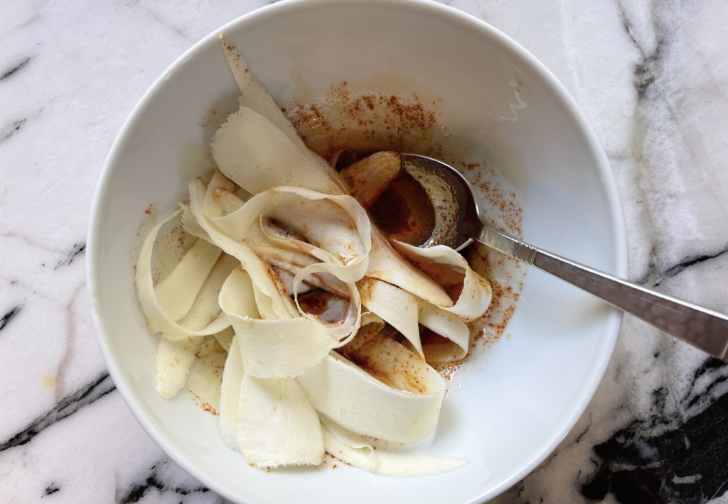 Transfer the parsnip ribbons into soy sauce mixture.