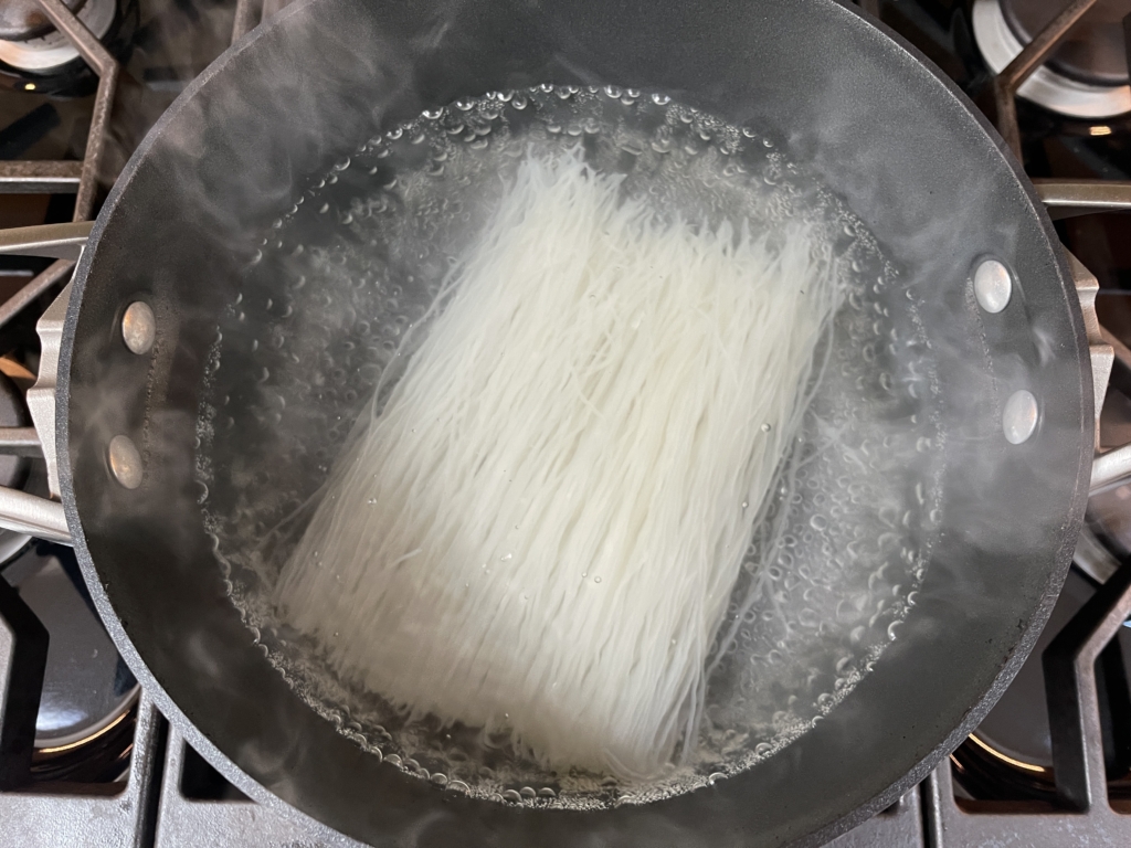 Place rice vericelli noodles into a pot of boiling water over medium high heat. Cook for 5 minutes or until noodles are soft.