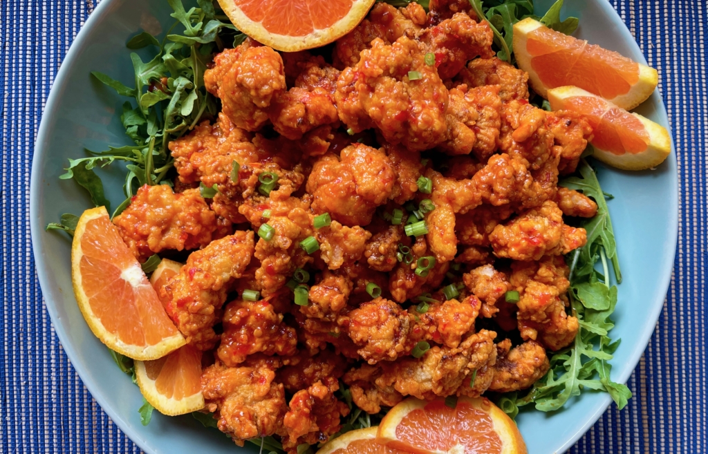 Harissa Honey Popcorn Chicken (Gluten Free). Transfer chicken to a platter. If desired, garnish with oranges or serve with crunchy raw or pickled vegetables such as radishes, cucumber spears, and carrot sticks, etc.