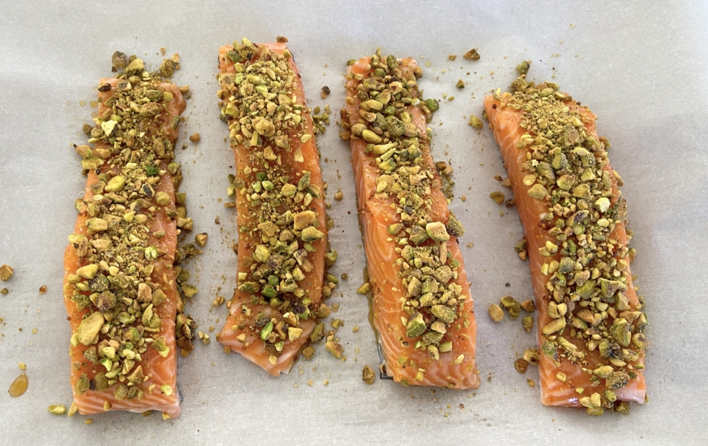 fillets.Then take 1-2 tablespoons of crushed pistachios and sprinkle them on top of each fillet using a spoon or your hand to gently press the pistachios onto the salmon.
