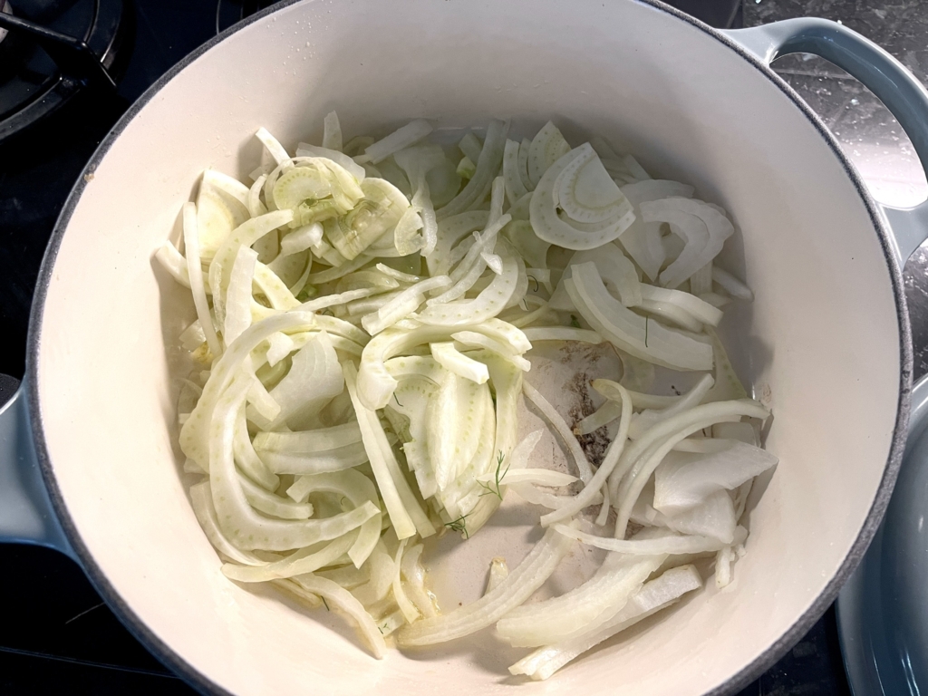 Heat ¼ cup oil in a large Dutch oven or other heavy pot over medium. Add fennel, onion, salt and sugar to the pan and use tongs to stir to combine. 