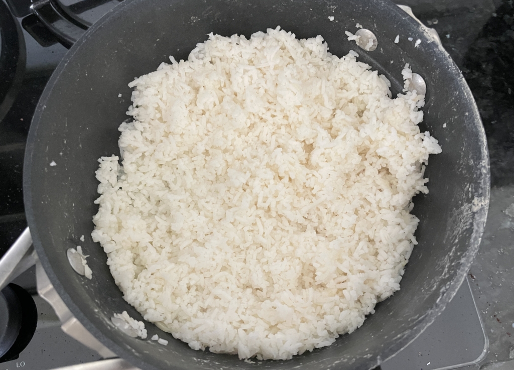 Fluff rice using a fork.