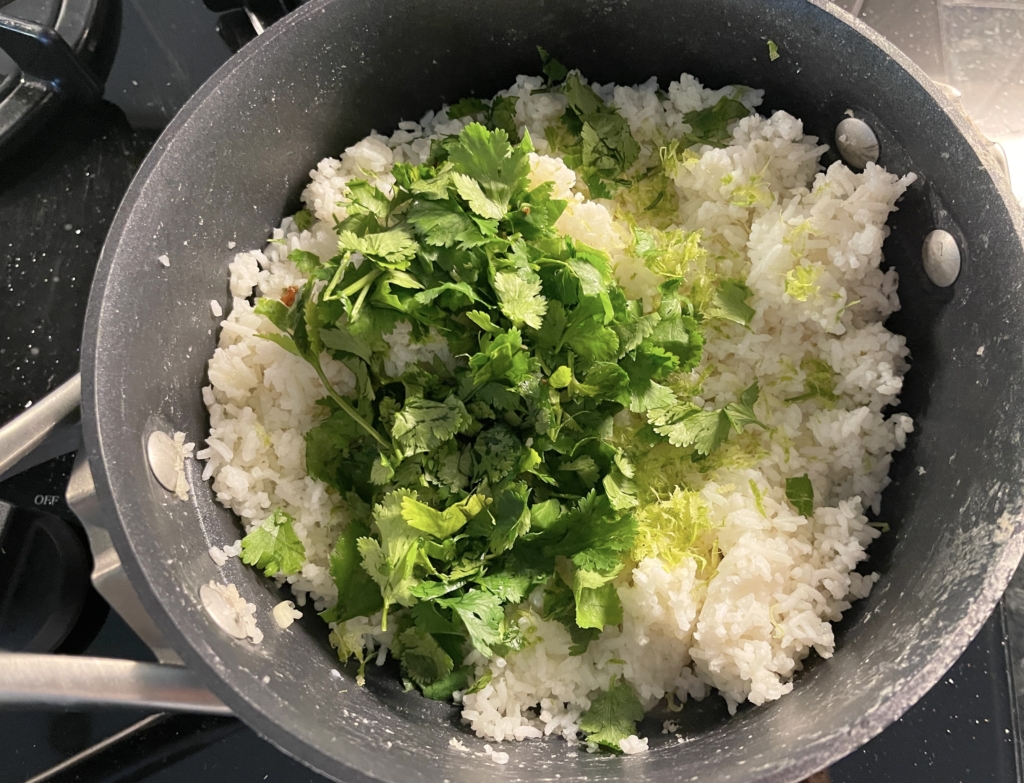 Add the butter, lime zest, lime juice, sugar, and most of the cilantro. Use a spoon or spatula to thoroughly combine making sure the butter is fully melted.