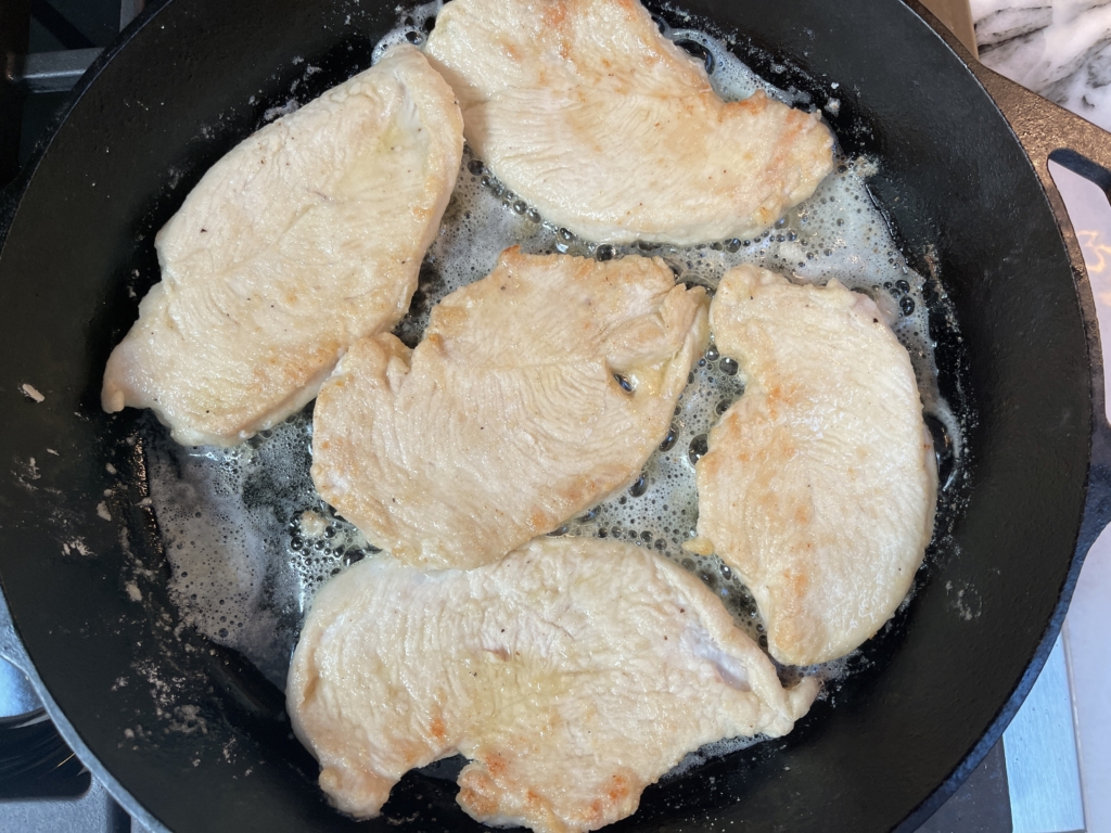 Flip chicken over using tongs and cook for an additional 2-3 minutes. Chicken will be slightly browned.