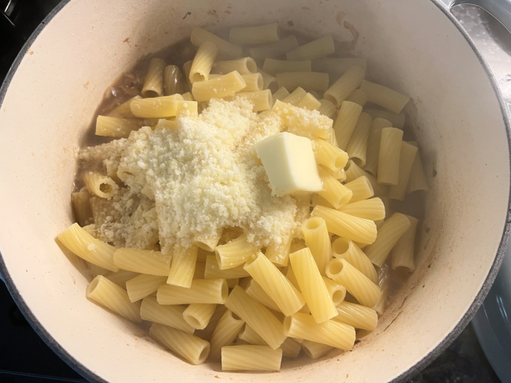 Drain pasta using a colander and transfer pasta to the pot with the onions and fennel. Add Parmesan, butter, and starchy water to the pot. Increase heat to medium-high and cook, stirring often, until sauce clings to pasta, about 2 minutes.