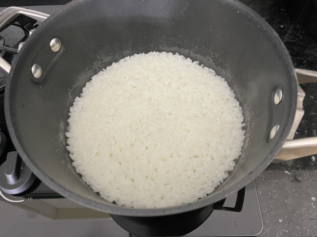 Cook the rice according to package directions. Leave rice in the pot until ready to transfer to the baking sheet.