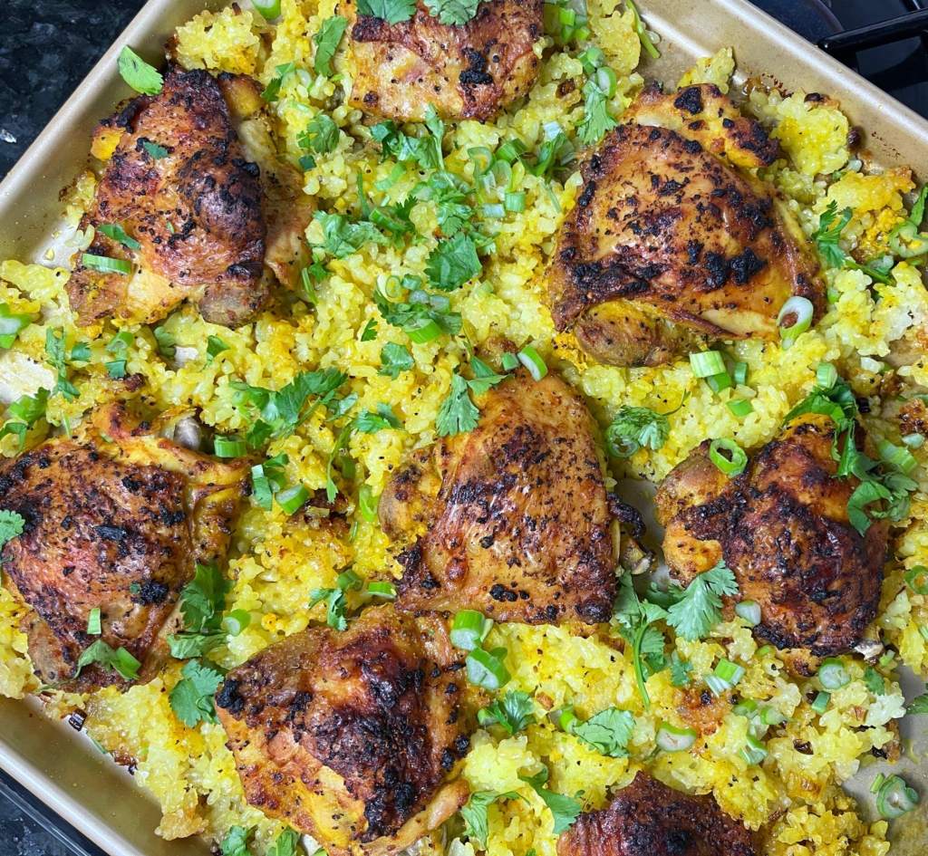 Use a spoon to dab or drizzle it onto the rice (not the chicken). Carefully stir up the rice on the baking sheet, so the crisp parts get mixed into the soft part of the rice, and the turmeric mixture gets distributed. Top everything with scallion greens and chopped fresh cilantro, and serve directly from the baking sheet.