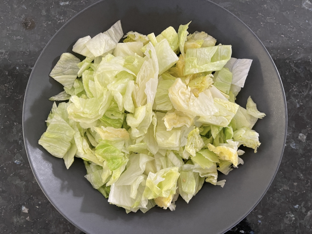 Place lettuce in a serving bowl