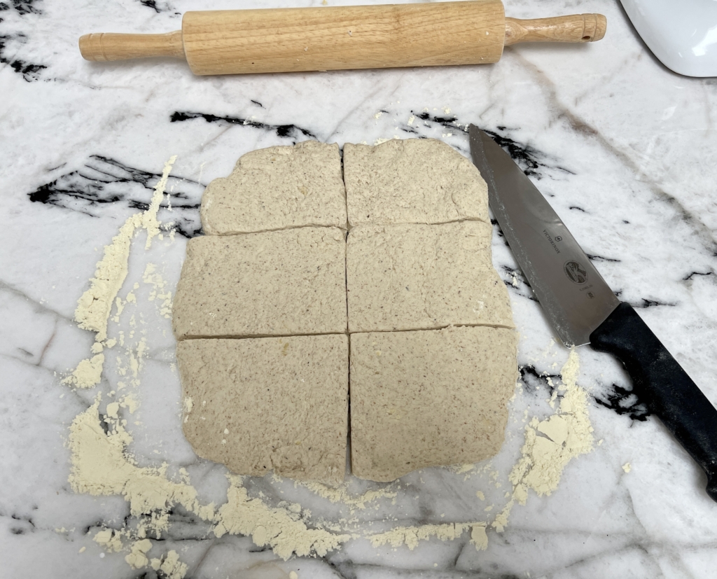 Use a bench scraper or a sharp knife to divide the dough into six fairly equal smaller rectangles. Don't worry if they're a bit uneven...ciabatta rolls are meant to be rustic!